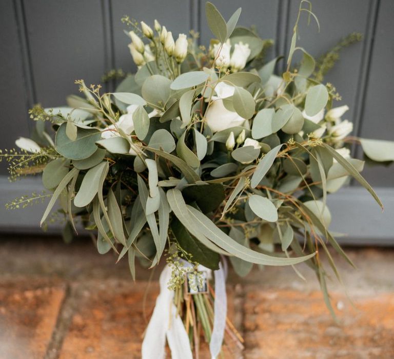 White wedding bouquet at outdoor celebration with donut wall