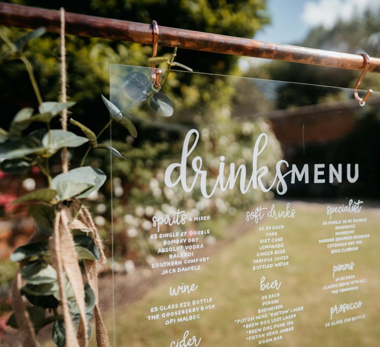 Acrylic wedding signs with donut wall and grazing table