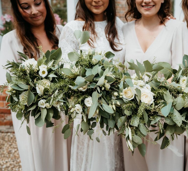 Foliage bouquets for bridesmaids at wedding with donut wall and BBQ meal