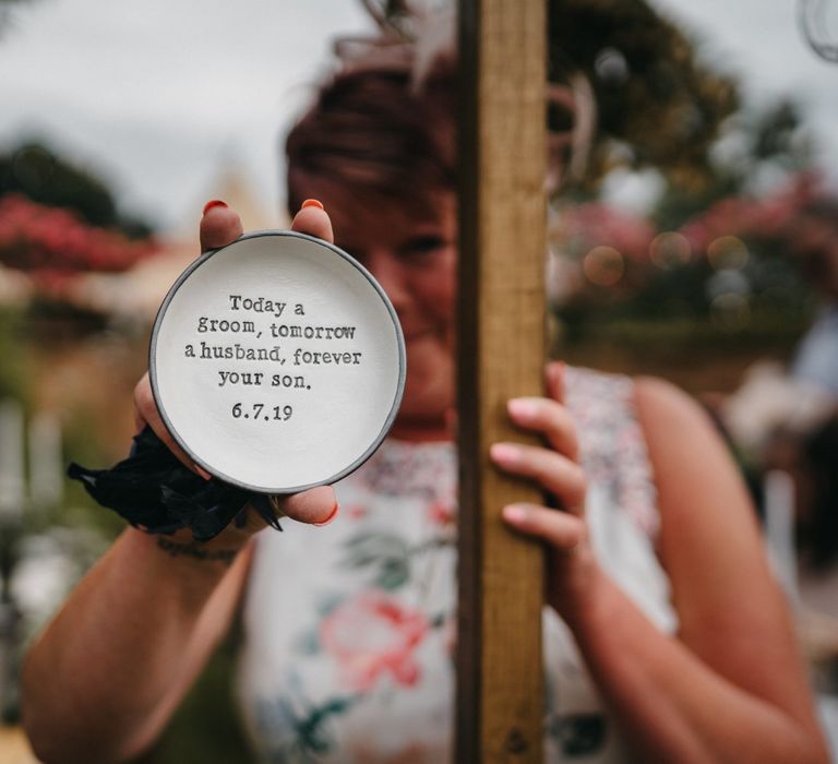 Present for groom's mother at outdoor wedding with donut wall