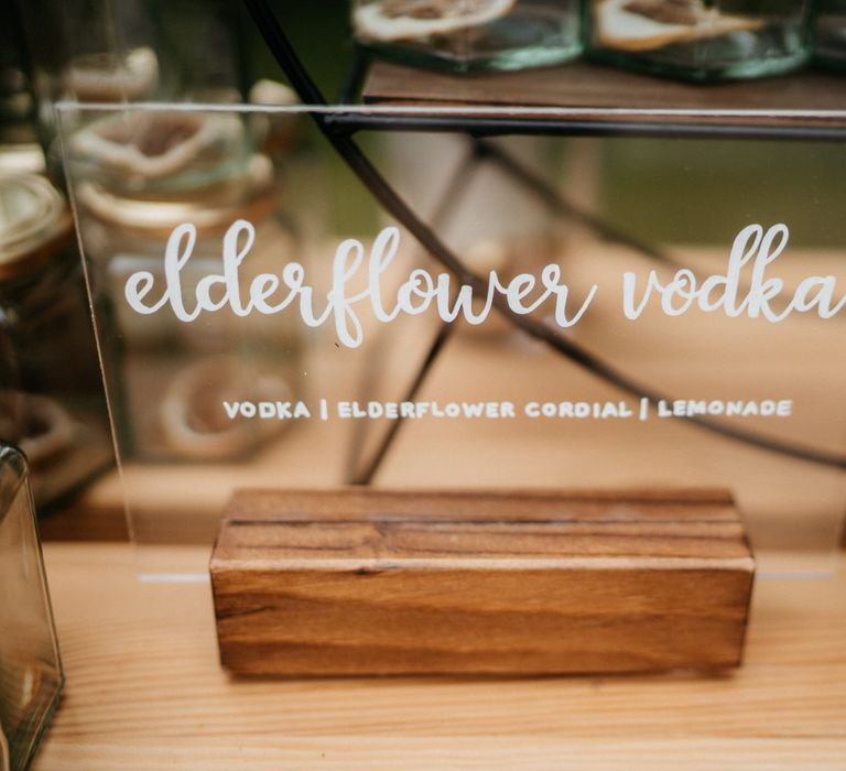 Acrylic wedding signs and donut wall at tipi wedding