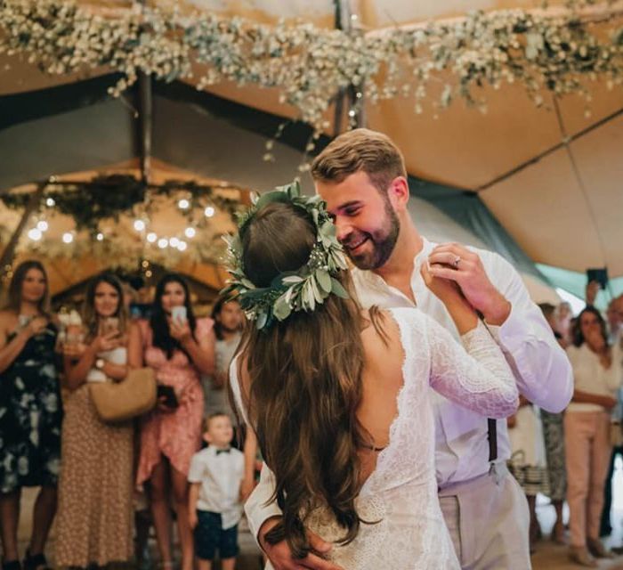 Bride and groom first dance with flower decor and donut wall  tipi wedding