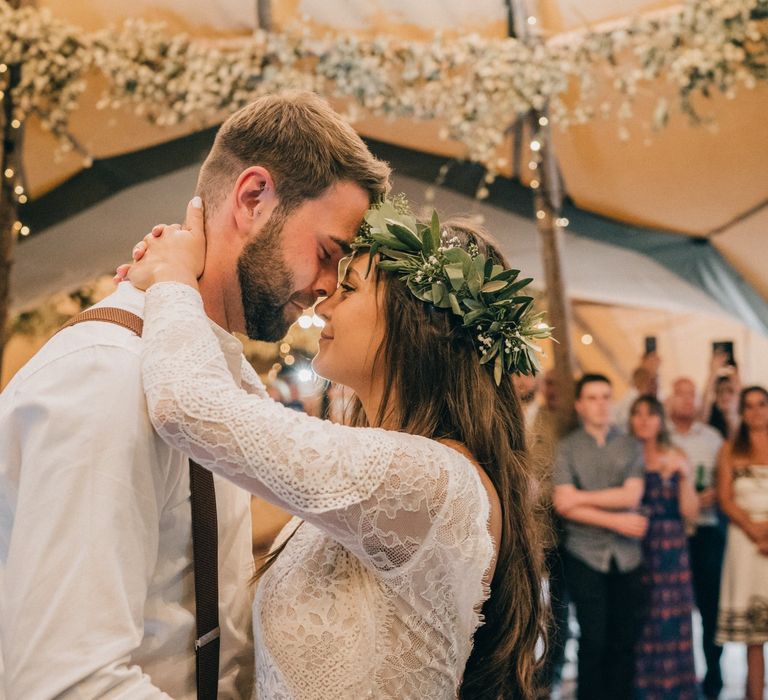 Bride and groom first dance with flower decor and donut wall wedding