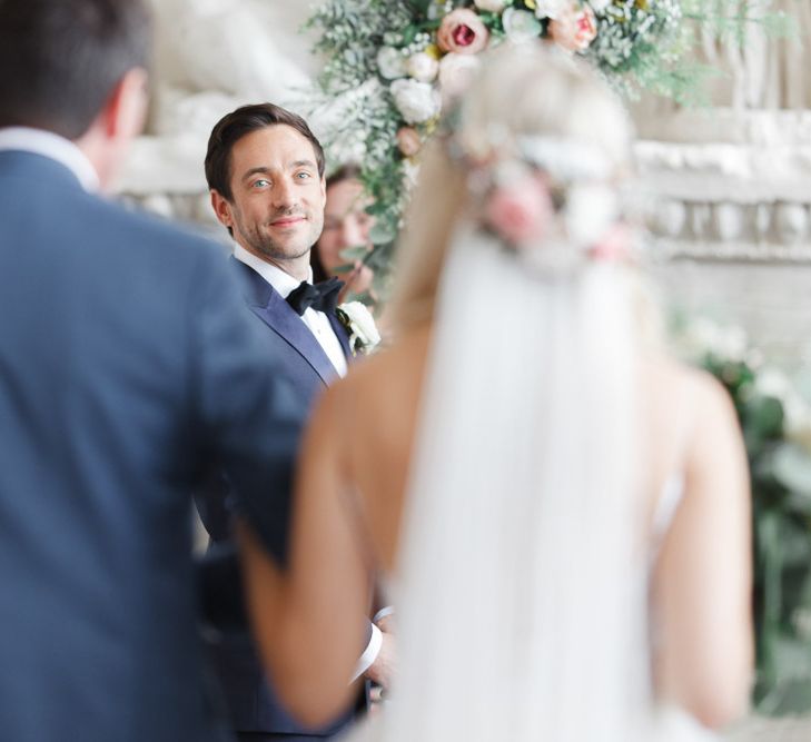 Groom watched bride walk up the aisle at whimsical wedding