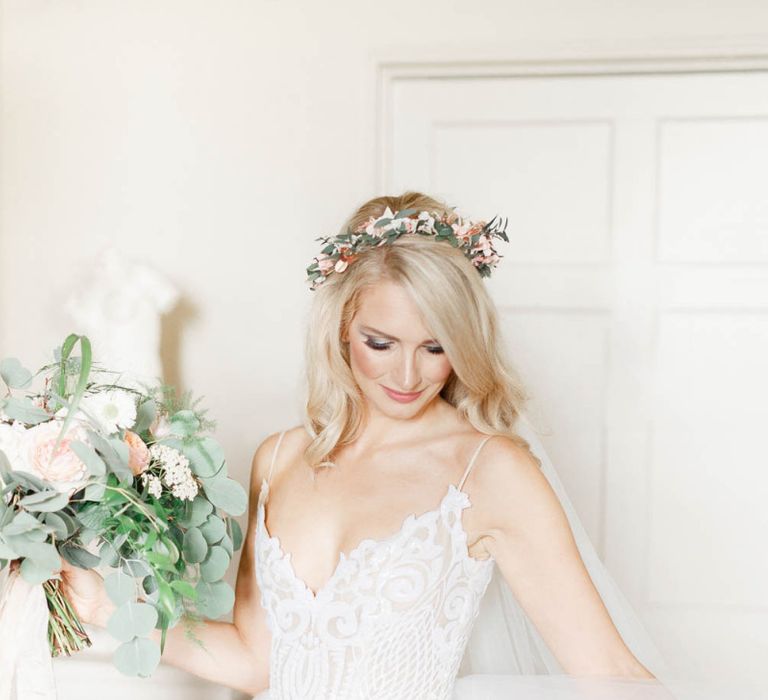 Bride in lace Hayley Paige wedding dress with bouquet and flower crown