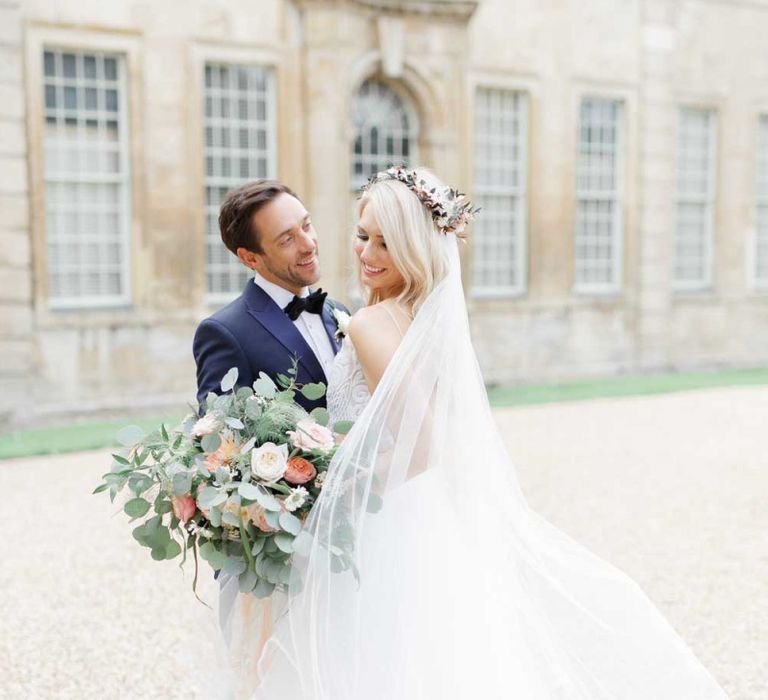 Lace wedding dress with big bouquet at whimsical wedding