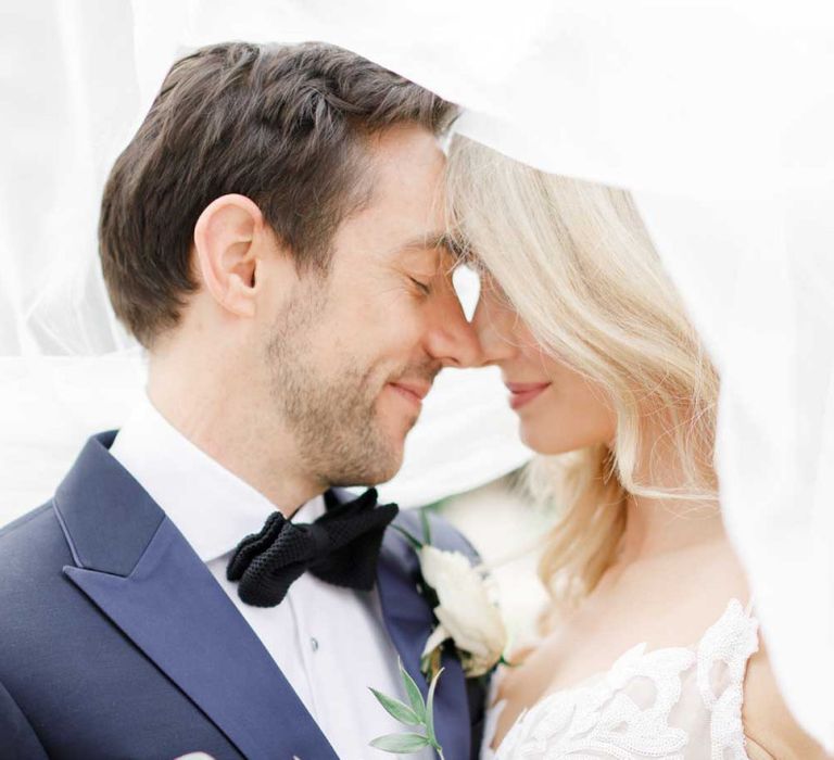 Lace detail bride dress with groom wearing tux and bowtie