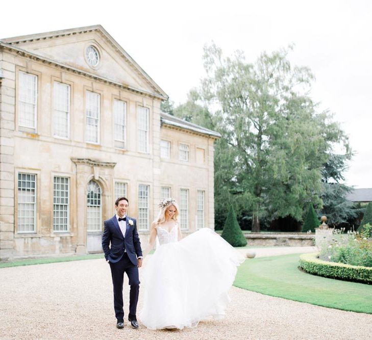 Bride and groom in front of Aynhoe Park wedding venue in Cotswolds