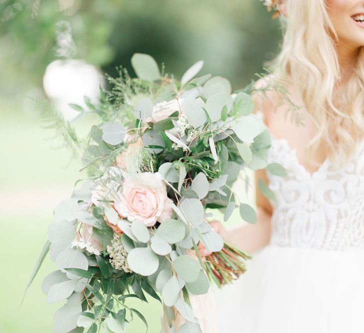 Bride with large flower and foliage bouquet at whimsical wedding