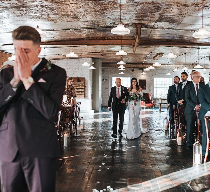 Bride in Lace Bardot Wedding Dress Walking Down the Aisle with Her Father towards Her Groom