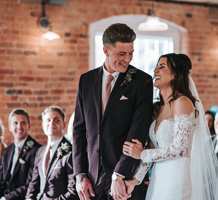 Bride and Groom Laughing During the Wedding Ceremony at The West Mill in Derbyshire