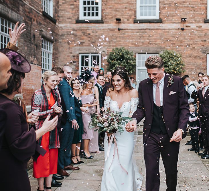 Confetti Moment with Bride in Lace Bardot Wedding Dress and Groom in Tailor Me Moss Bros. Suit