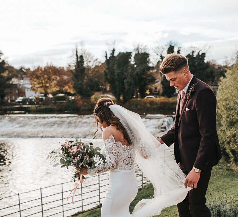 Bride in Pronovias Dracma Bardot Wedding Dress and Groom in Tailor Me Moss Bros. Suit Walking Down the Steps