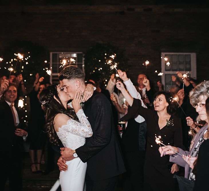 Sparkler Exit with Bride in Pronovias Dracma Bardot Wedding Dress and Groom in Tailor Me Moss Bros. Suit