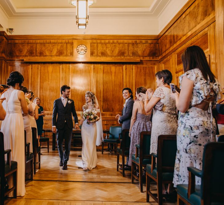 Wedding Ceremony at Hackney Town Hall with Bride in Lace Off The Shoulder Jennifer Regan Wedding Dress and Flower Crown and Groom in Grey Suit