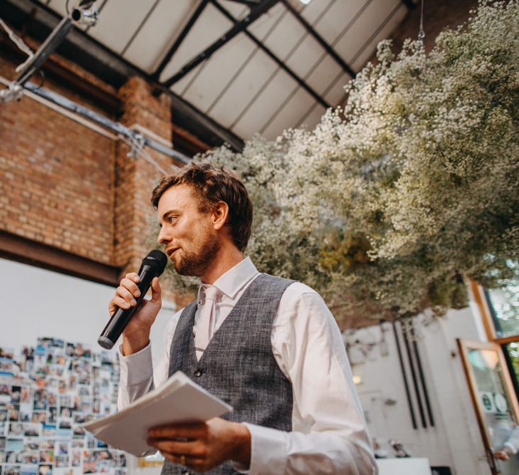 Groom in Grey Waistcoat Giving His Wedding Speech Under a Gypsophila Flower Cloud