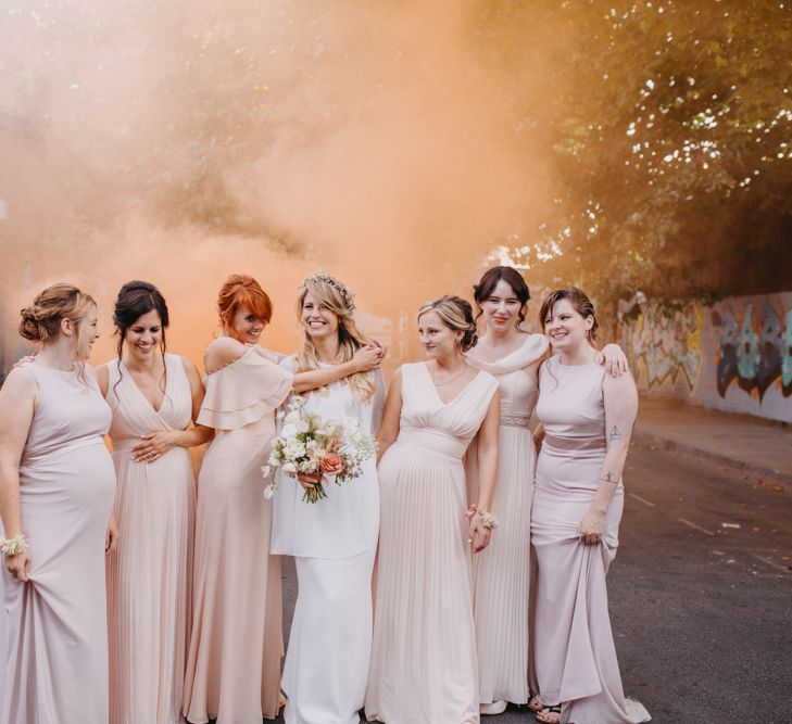 Bridal Party Portrait with Bridesmaids in Blush ASOS Dresses and Bride in ace Off The Shoulder Jennifer Regan Wedding Dress with Smoke Bombs Going Off in the Background