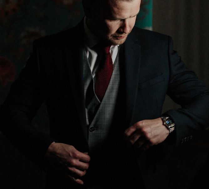 Groom in Navy Marks and Spencer Suit with Check Waistcoat and Deep Red Tie