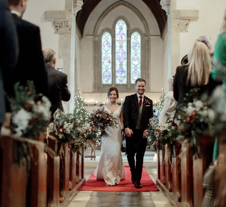 Bride in Essense of Australia Wedding Dress and Groom in Marks and Spencer Suit Walking Up the Church Aisle