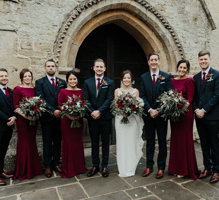 Wedding Party Portrait with Bridesmaids in Red Dresses, Bride in Essense of Australia Wedding Dress and Groomsmen in Marks and Spencer Suits