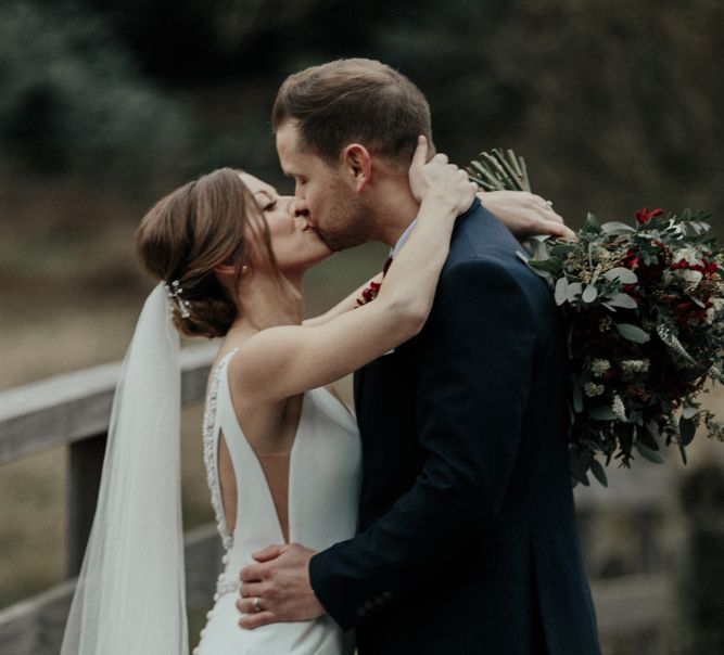 Bride in Essense of Australia Wedding Dress and Cathedral Veil and Groom in Marks and Spencer Suit