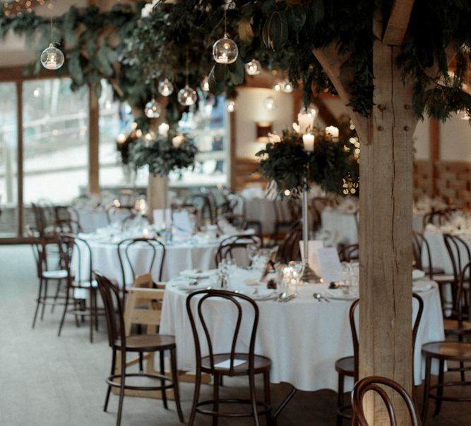 Cripps Barn wedding Reception Decor with Foliage and Candle Light