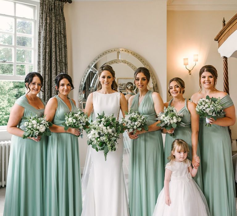 Bridal Party Portrait with Bridesmaids in Pale Green Multiway Dresses and Bride in Pronovias Wedding Dress