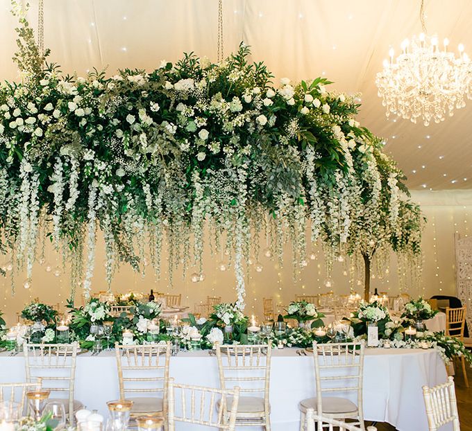 White Flower and Green Foliage Floral Installation Over the Top Table by Red Floral Architecture