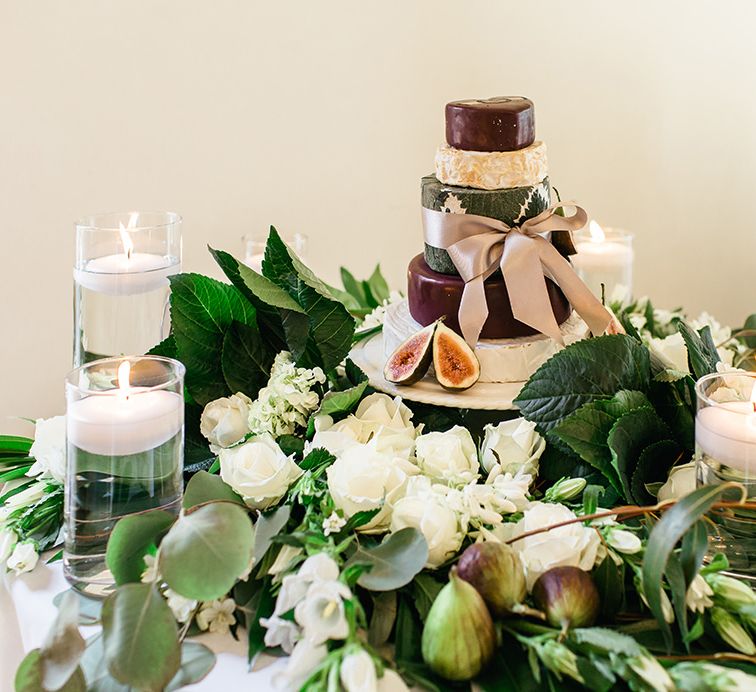 Cheese Tower Surrounded by White Flowers, Foliage and Candles