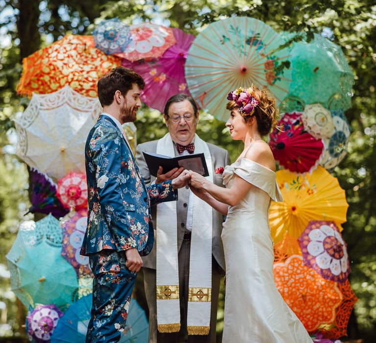 Parasol Wedding Ceremony Backdrop // Secret Garden Party Inspired Wedding France Bride In Large Faux Floral Crown And Glitter Station With Groom In Floral Print Suit &amp; Images From The Shannons