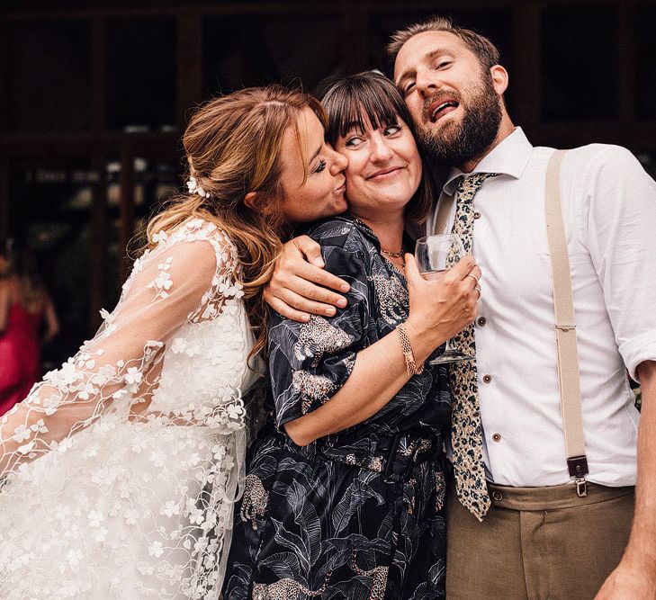 Bride and groom pose with wedding guests at Nancarrow Farm