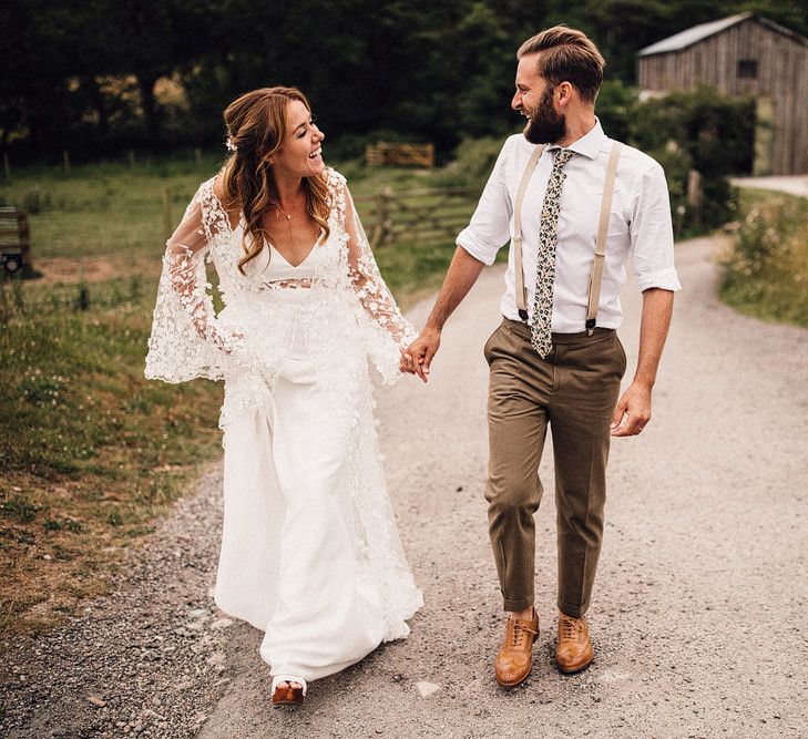 Bride and groom wander through the grounds of Cornwall wedding venue