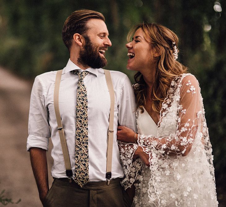 Groom wears braces and floral tie