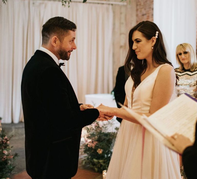 Bride and groom exchange rings at Healing Manor wedding