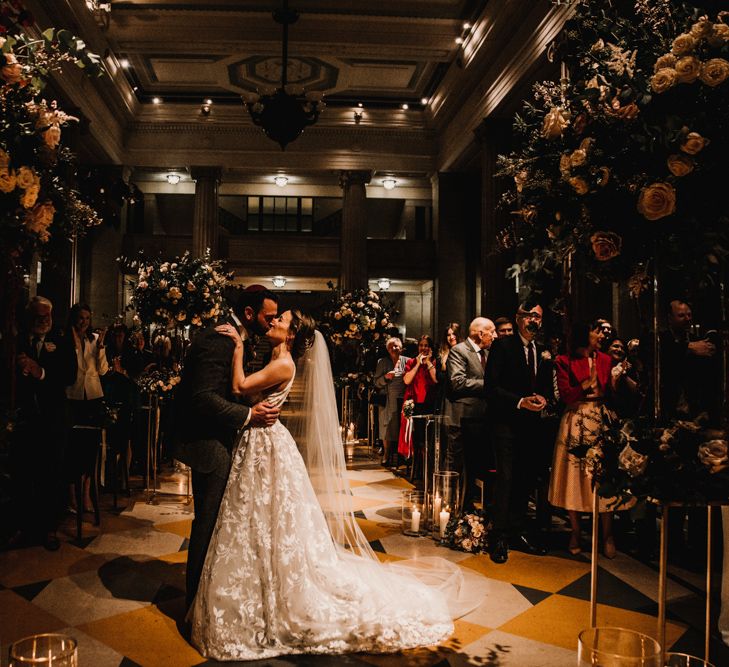 Bride in Fleur de lis Hayley Paige Wedding Dress  and Groom in Dark Suit Kissing at Jewish Blessing