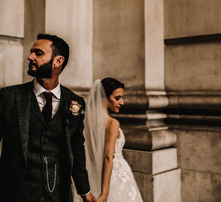 Groom in Wool Walker Slater Three-piece Suit and Bride in Hayley Paige Wedding Dress