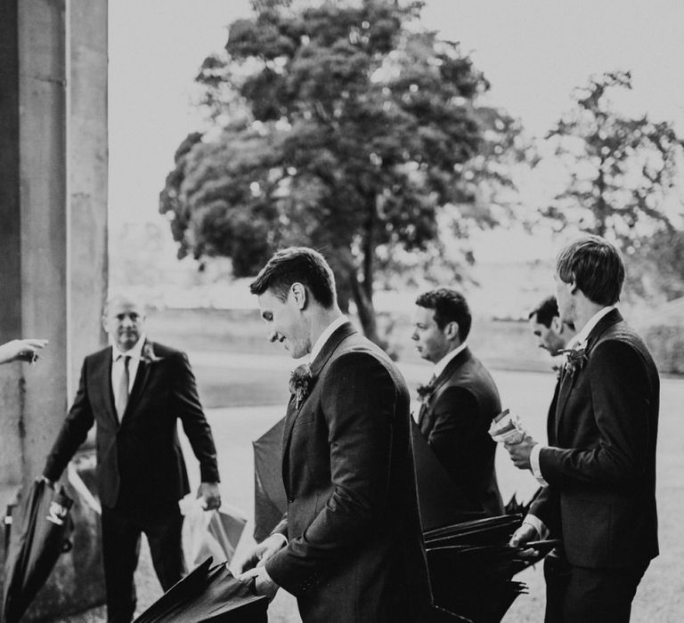 Groomsmen Holding Umbrellas