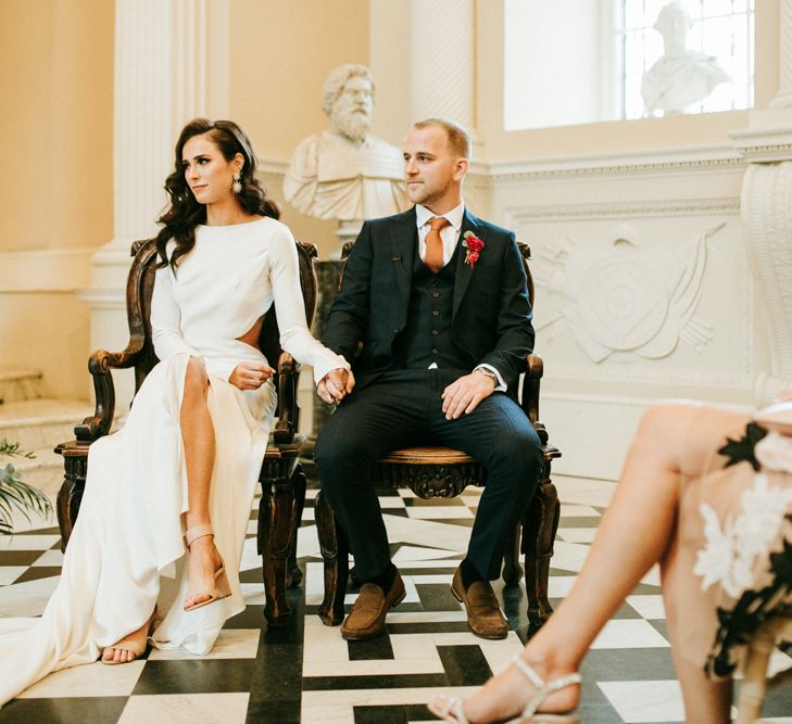 Bride and Groom Holding Hands During The Wedding Ceremony