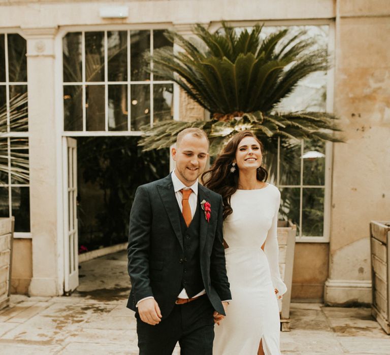 Groom and Bride in Front Split Wedding Dress Walking into the Wedding Reception