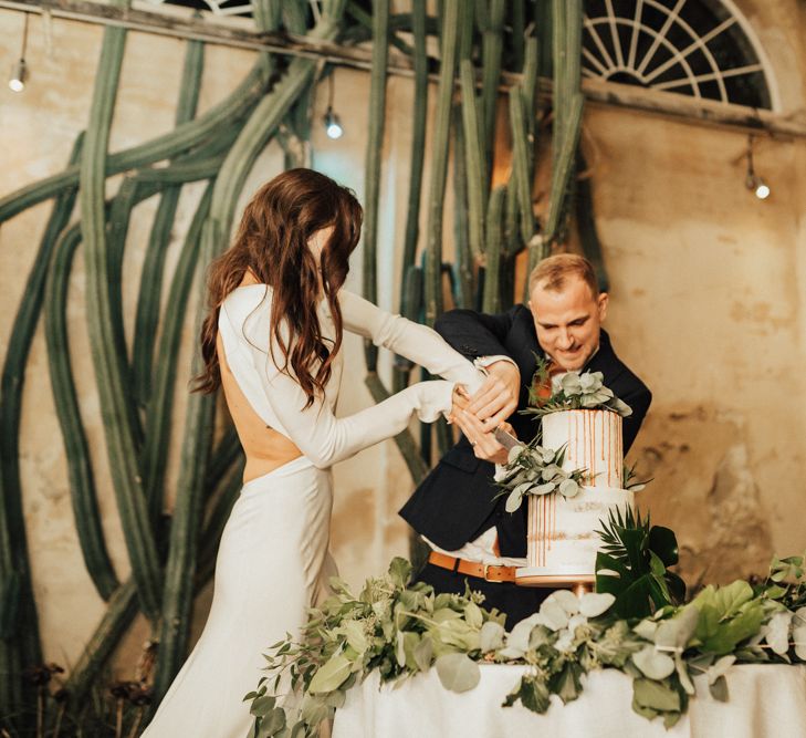 Bride and Groom Cutting The Wedding Cake