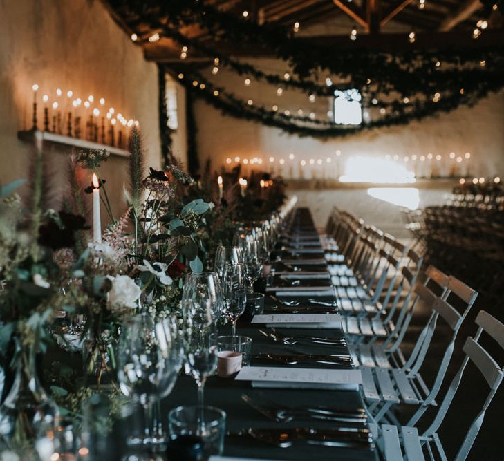 Atmospheric Wedding Reception With Candles And Bud Vase Floral Arrangements