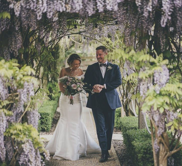 Bride in flat wedding shoes walks up to outdoor ceremony