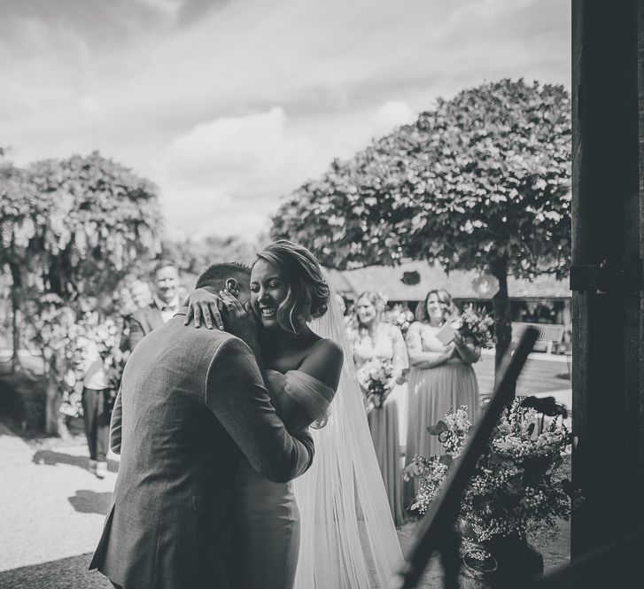 Barn wedding with bride in flat wedding shoes and lilac flowers