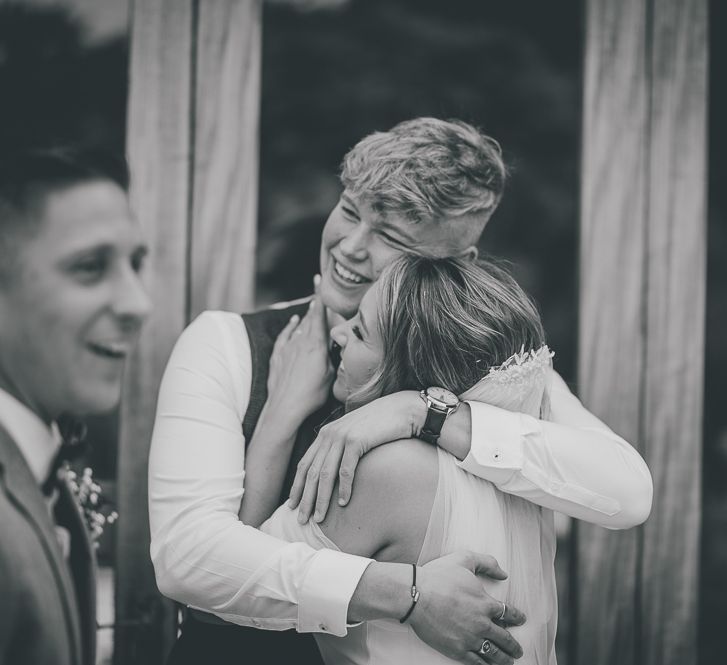 Bride greets guests at outdoor wedding