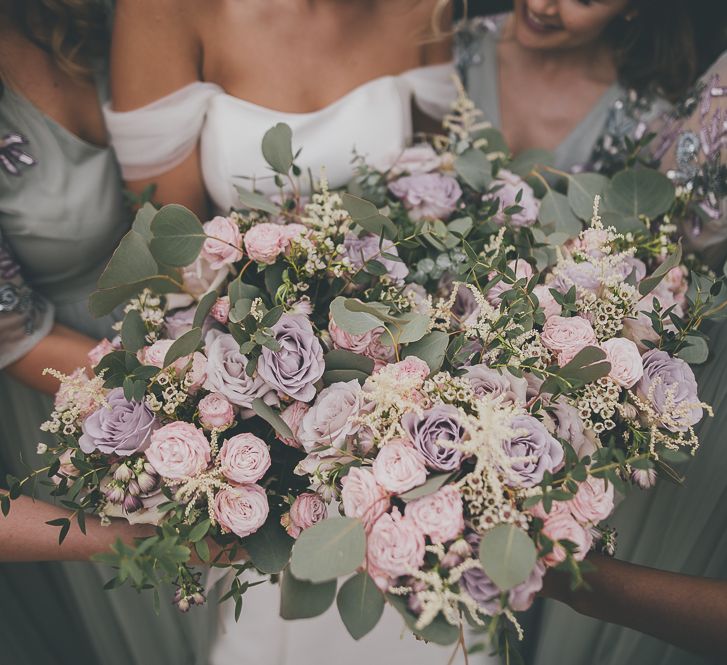 Stunning lilac wedding bouquets for bridal party at rustic barn wedding