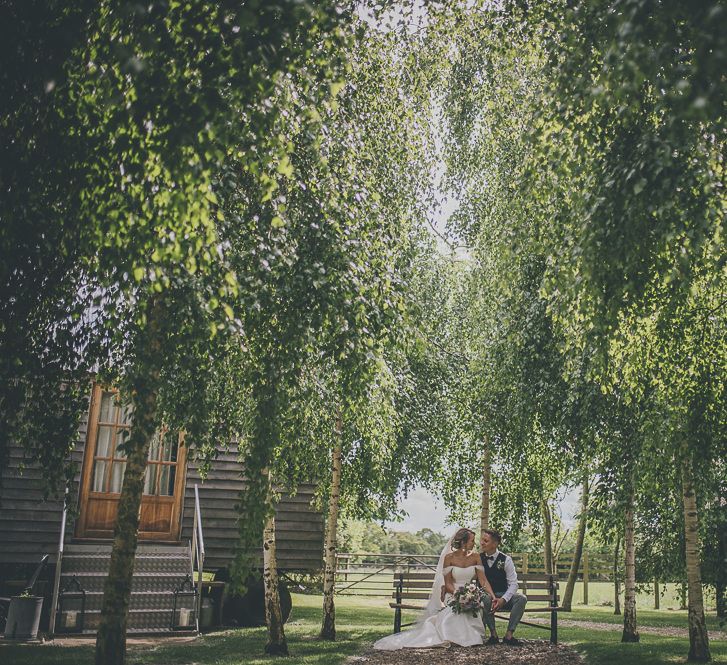 Bride and groom in ground of Tythe Barn wedding venue