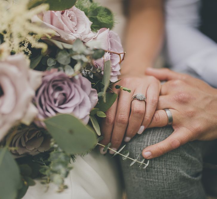 Lilac wedding bout with bride and groom wedding rings