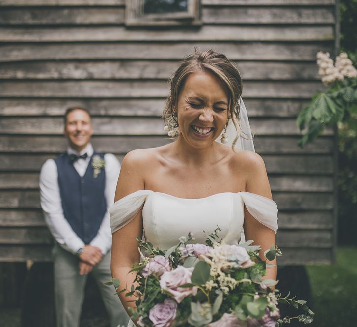 Bride in off the shoulder wedding dress and groom at Tythe Barn wedding venue