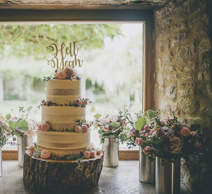 Semi-naked wedding cake with cake topper