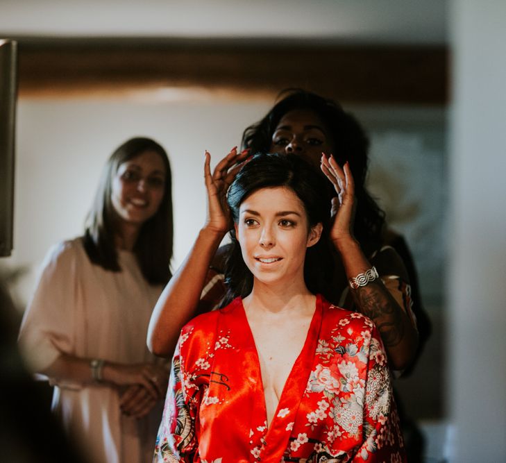 Bride Having Her Wedding Hair and Makeup Done in Red Getting Robe